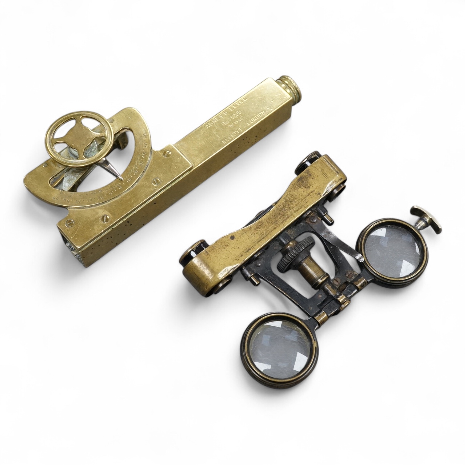 A brass Abney’s level by Elliott, London, 12cm long, together with a pair of folding brass miniature binoculars, 10cm wide.